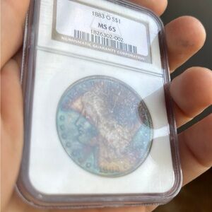 1883-O Morgan silver dollar with monster toning.